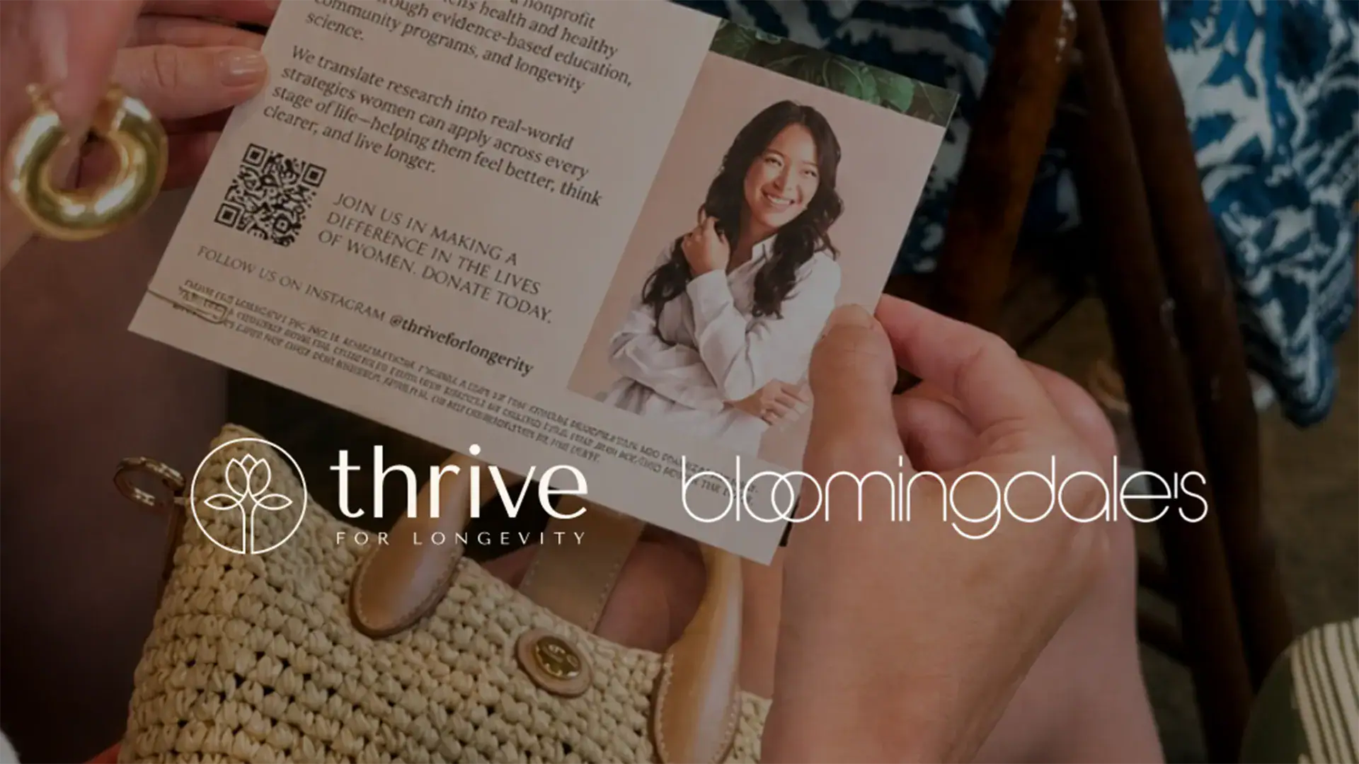 Person holding a Thrive for Longevity informational brochure featuring a QR code, donation message, and partnership with Bloomingdale’s.