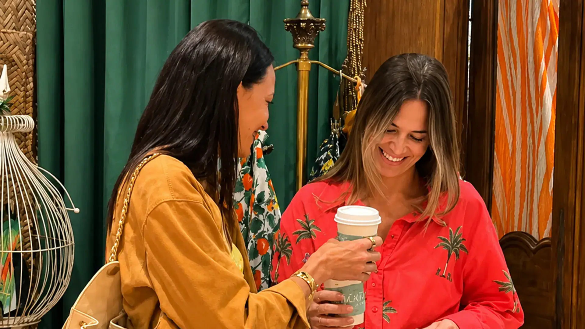 Two attendees smiling and connecting while shopping during a Thrive for Longevity community event.